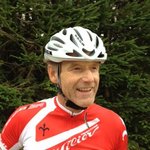 Mountain biking in South Tyrol © Hotel Exclusive Man in red cycling jersey and white helmet in front of pine tree