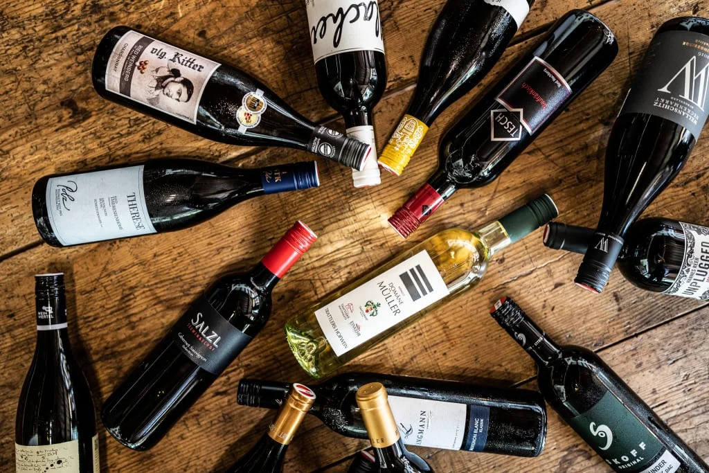 Various wine bottles lying on a wooden table