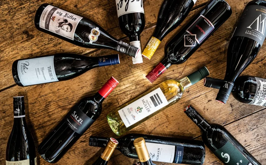 Winemaker on the mountain summer & autmun - 2 nights Various wine bottles lying on a wooden table