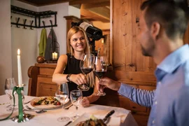 Couple toasting with red wine in cozy restaurant