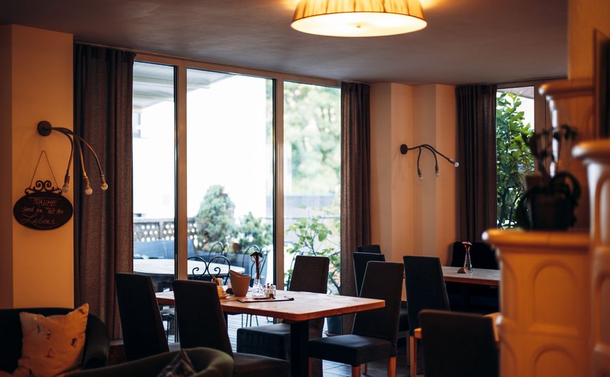 Cozy restaurant with wooden tables and large glass windows