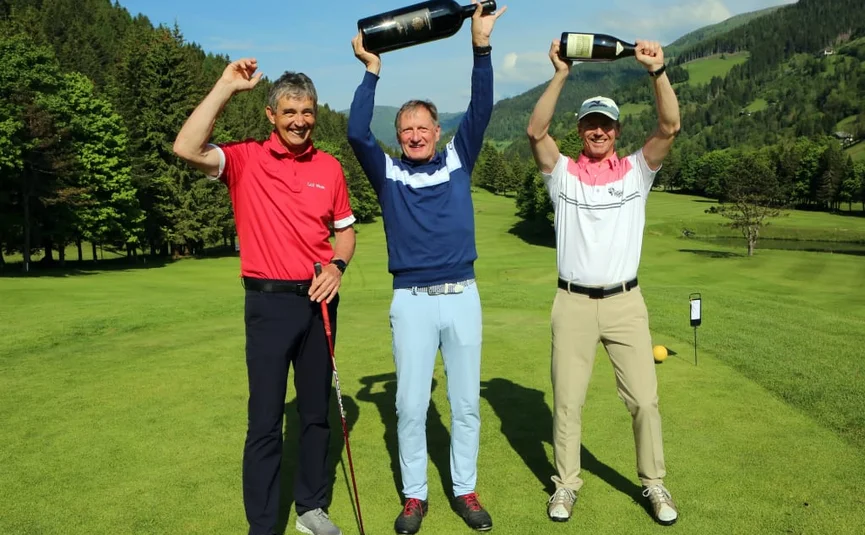 15. Charity Wine & Golf Cup / 3 nights Three men celebrating on golf course holding large wine bottles