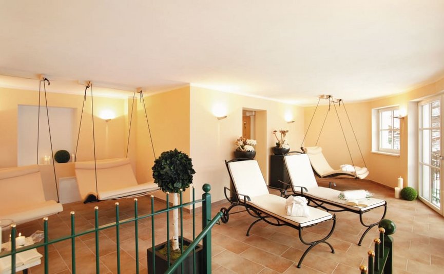 Calm wellness room with loungers and hanging chairs