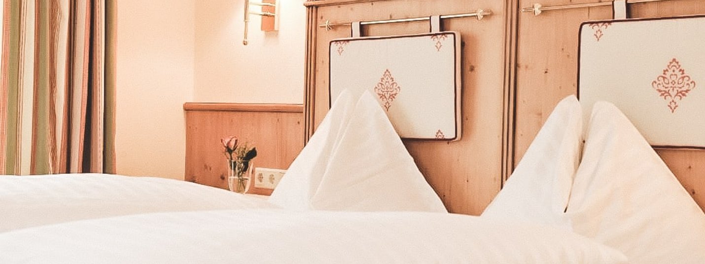 Cozy bedroom with decorative wooden and fabric headboard
