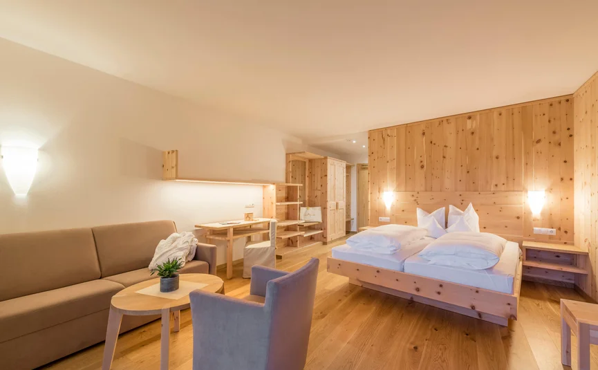 Cozy hotel room with wooden paneling and modern furniture