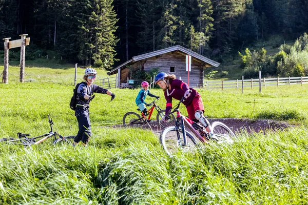 Biking with the family © Klemens König Kids learning mountain biking with helmets in rural setting