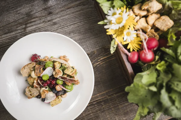 Bike & Kulinarik © Hannes Niederkofler Salat und Gemüsesnack auf weißem Teller auf Holztisch