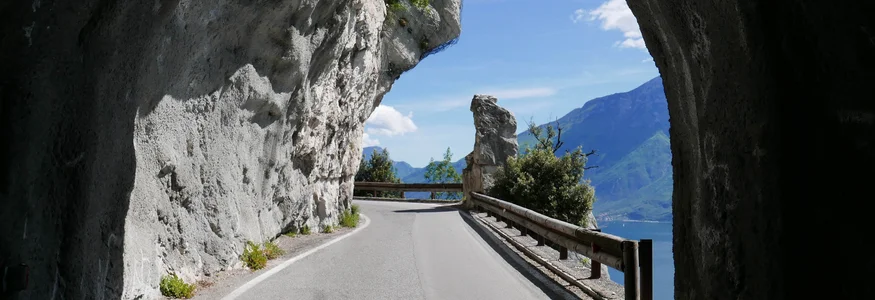 Unterwegs auf der Bond-Straße © Tobias Köhler Bergstraße mit Tunnelöffnung und Blick auf See und Berge