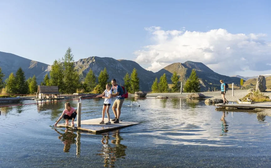 Family time at the GUTshof / 7 nights - kids free Family fishing on wooden platform in mountain lake under clear sky