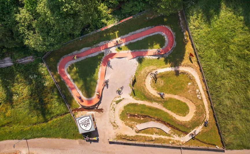 Aerial view of a bike park with riders on various trails