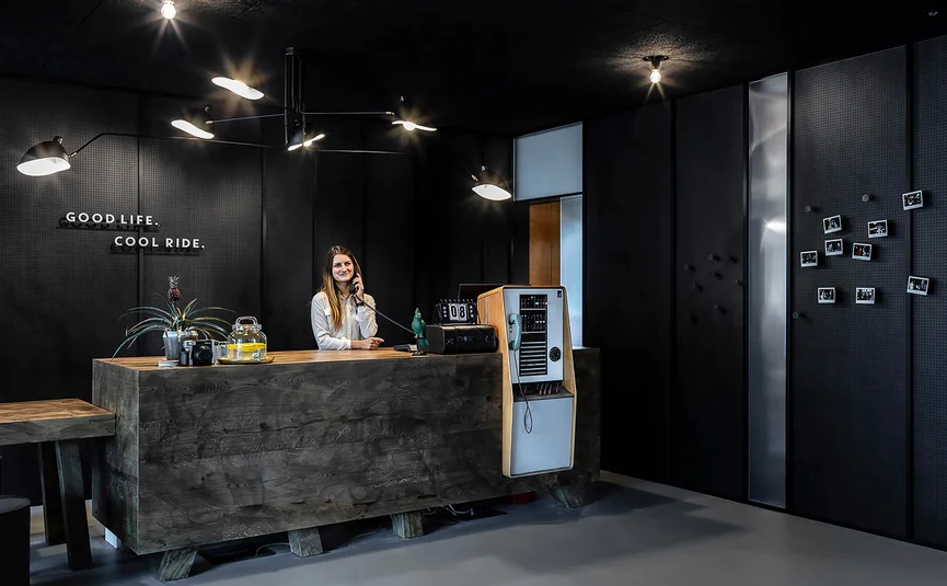 Reception area with dark decor and woman on the phone