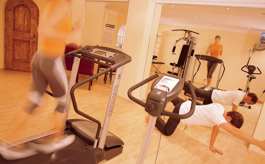 People working out in gym using treadmill and bodyweight exercises