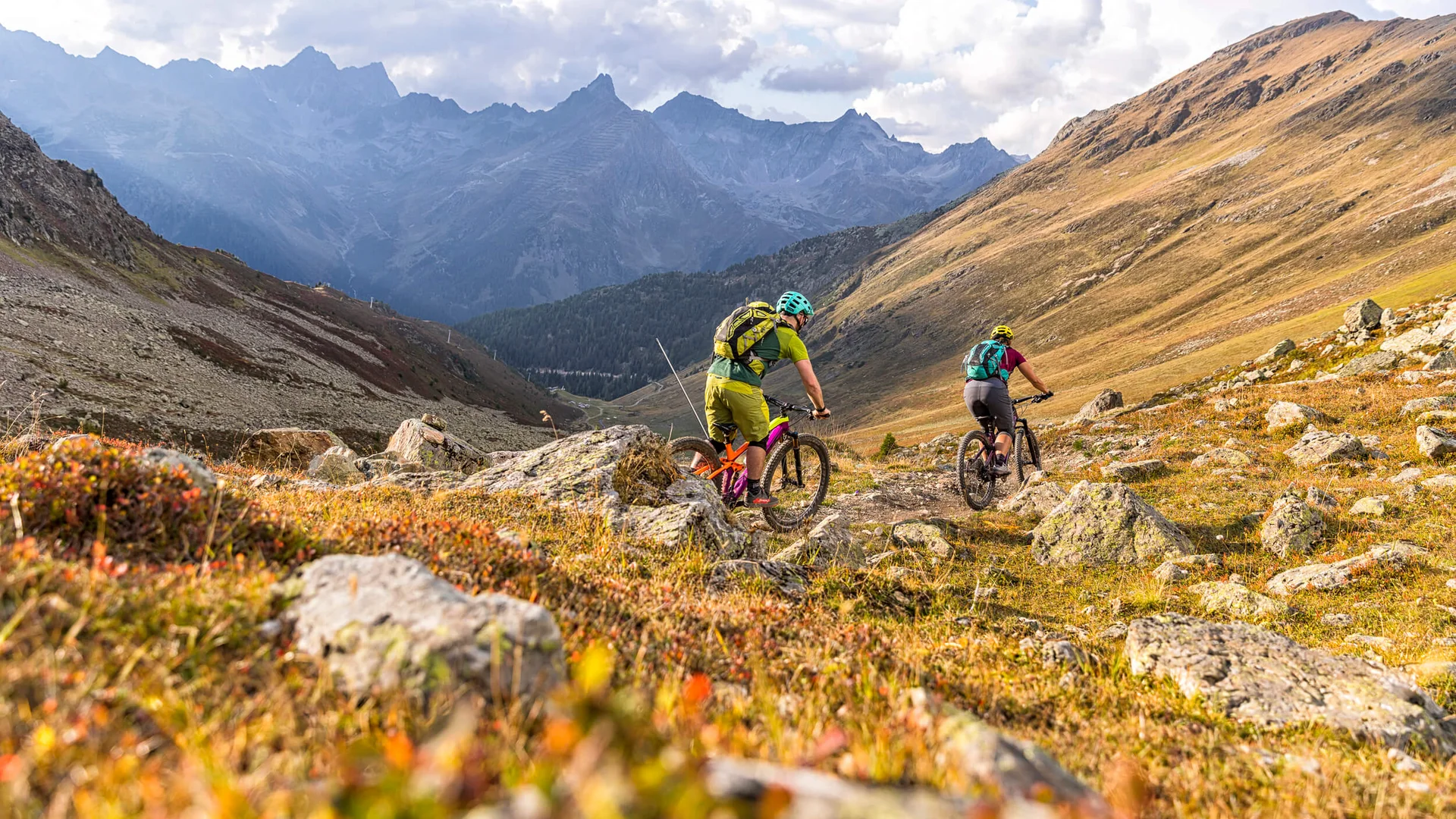 Zwei Mountainbiker fahren auf einem Bergpfad in den Alpen