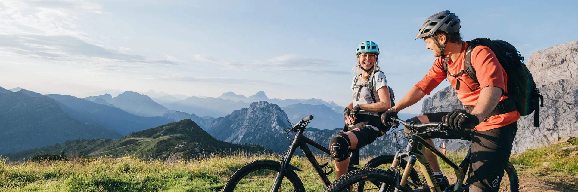 Zwei Mountainbiker machen Pause in den Bergen bei Sonnenuntergang