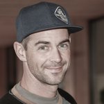 Porträt eines lächelnden Mannes mit schwarzer Baseballkappe