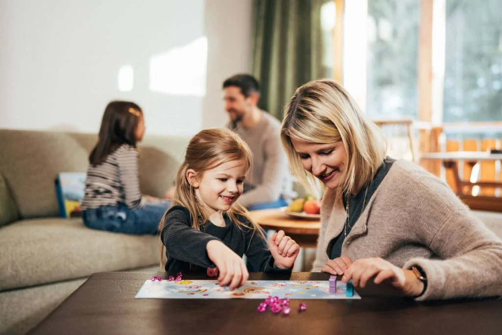 Family playing a board game together in the living room