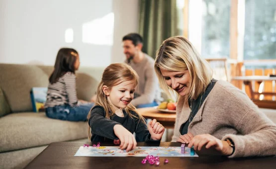 Family time at the GUTshof / 7 nights - kids free Mother and daughter playing a board game together at the table