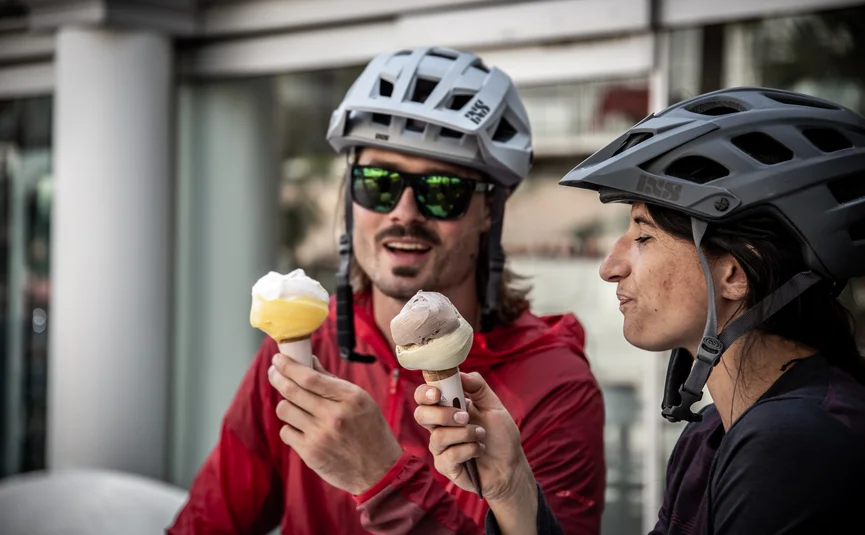 Two cyclists enjoying ice cream outdoors