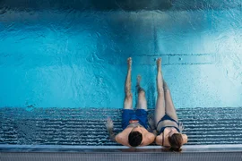 Mountain-Lake experience / 3 nights Couple sitting at the edge of a pool with blue water