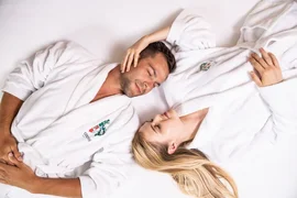 Wellness & Thermal spa - 3 nights Couple wearing white bathrobes lying relaxed next to each other