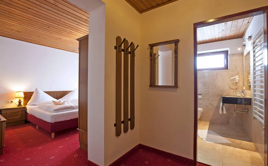 Uitzicht vanuit hal naar slaapkamer en badkamer van hotelkamer