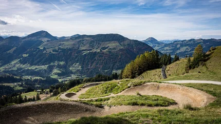 Kirchberg Trail Mountain bike trail with mountains and blue sky in the background