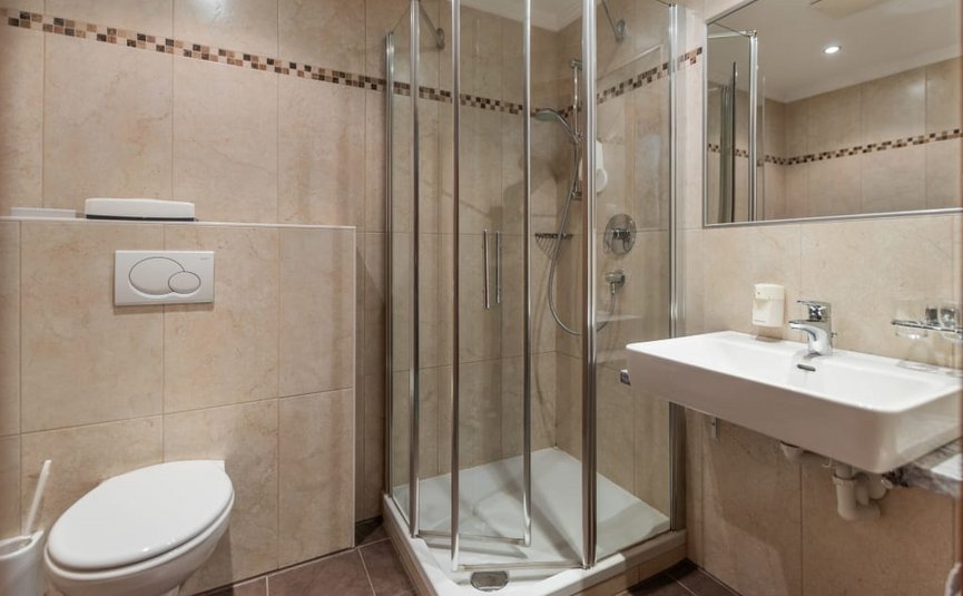 Small bathroom with shower, toilet, and sink