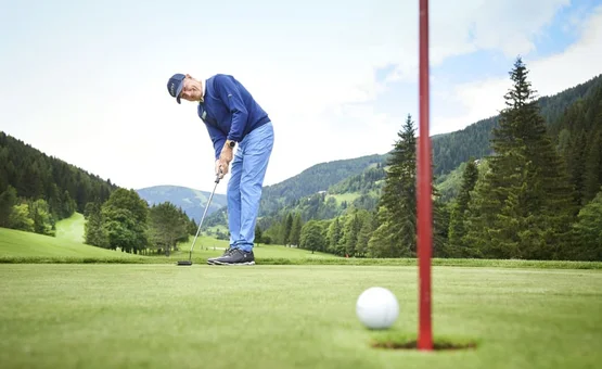 15. Charity Wine & Golf Cup / 3 nights Man playing golf on green course with mountains in the background