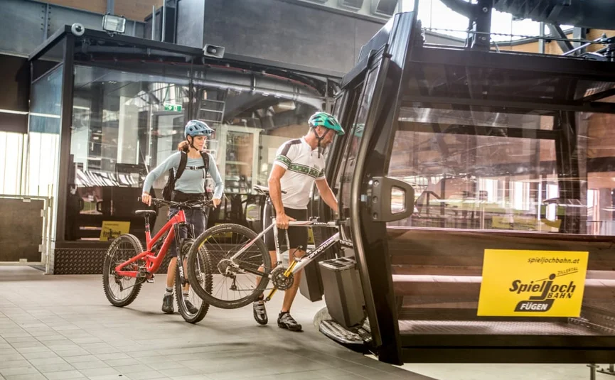 Bike week Two cyclists boarding a cable car with their bikes