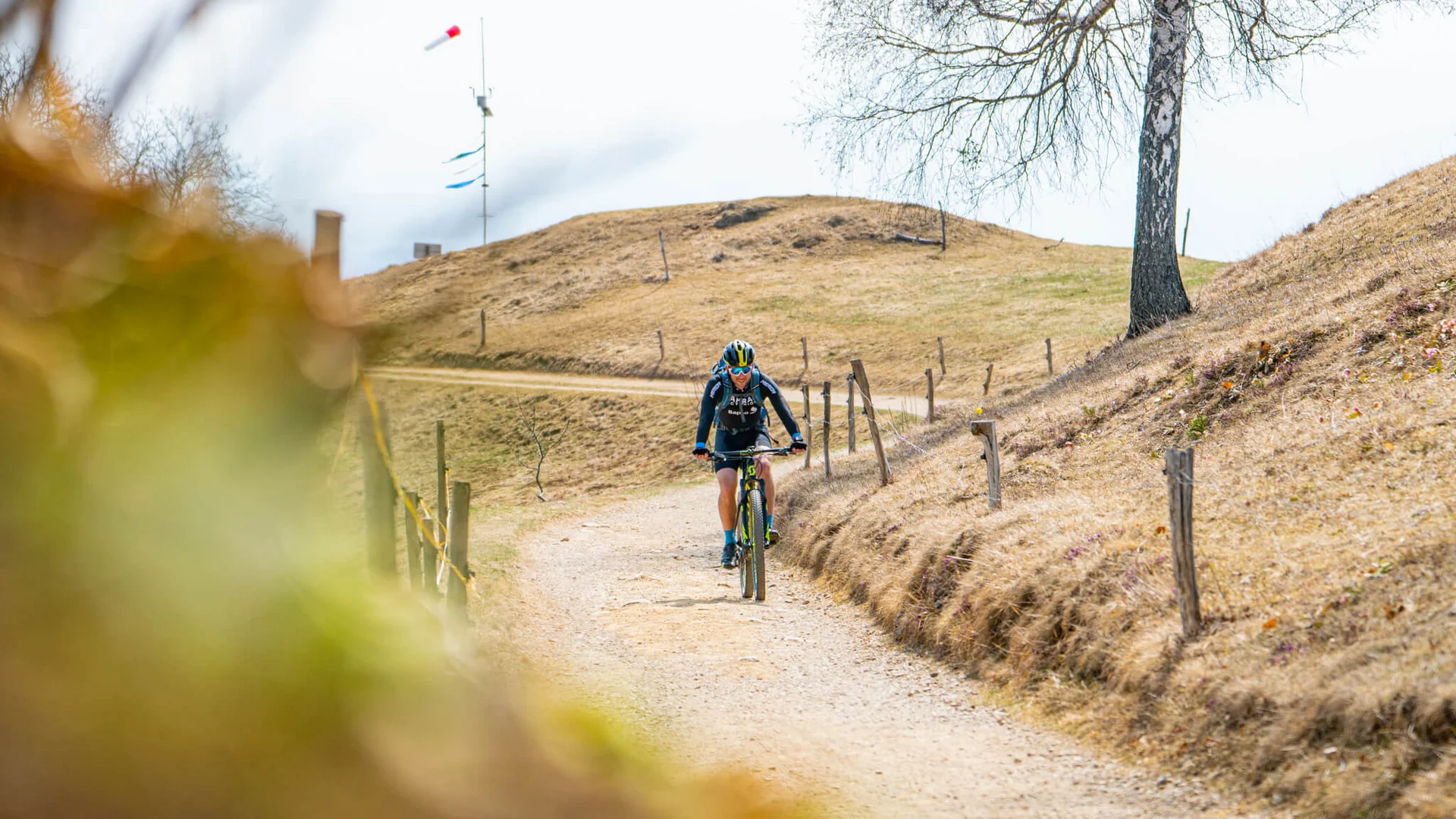 Dein Julische Alpen-Guide © Radovljica - Nejc Vurnik Mountainbiker auf einem kurvigen Weg im trockenen, hügeligen Gelände