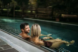 Winemaker on the mountain summer & autmun - 2 nights Couple relaxing in heated outdoor pool with wooden fence in background