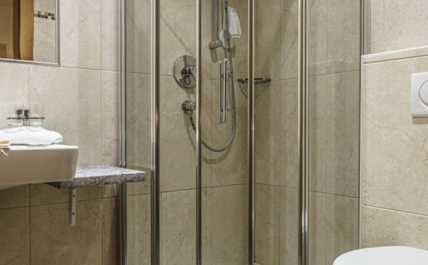 Activity holidays Modern bathroom with corner shower, sink, and toilet