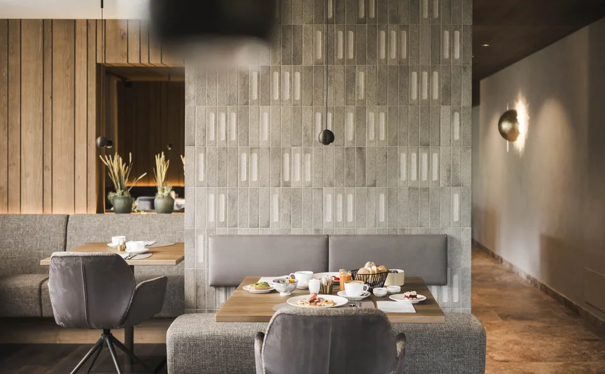 Modern dining room with set table and decorative plants