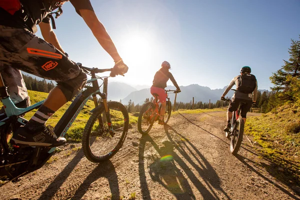 Best of Brandnertal © Michael Marte - Bikepark Brandnertal Three mountain bikers riding on sunny mountain trail with mountains behind
