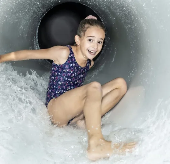 Autumn Experience Days Girl happily sliding down a water slide