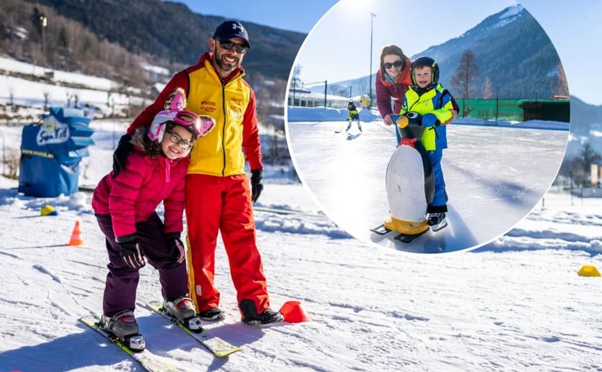 Skileraar en kinderen leren skiën en schaatsen bij zonnig winterweer
