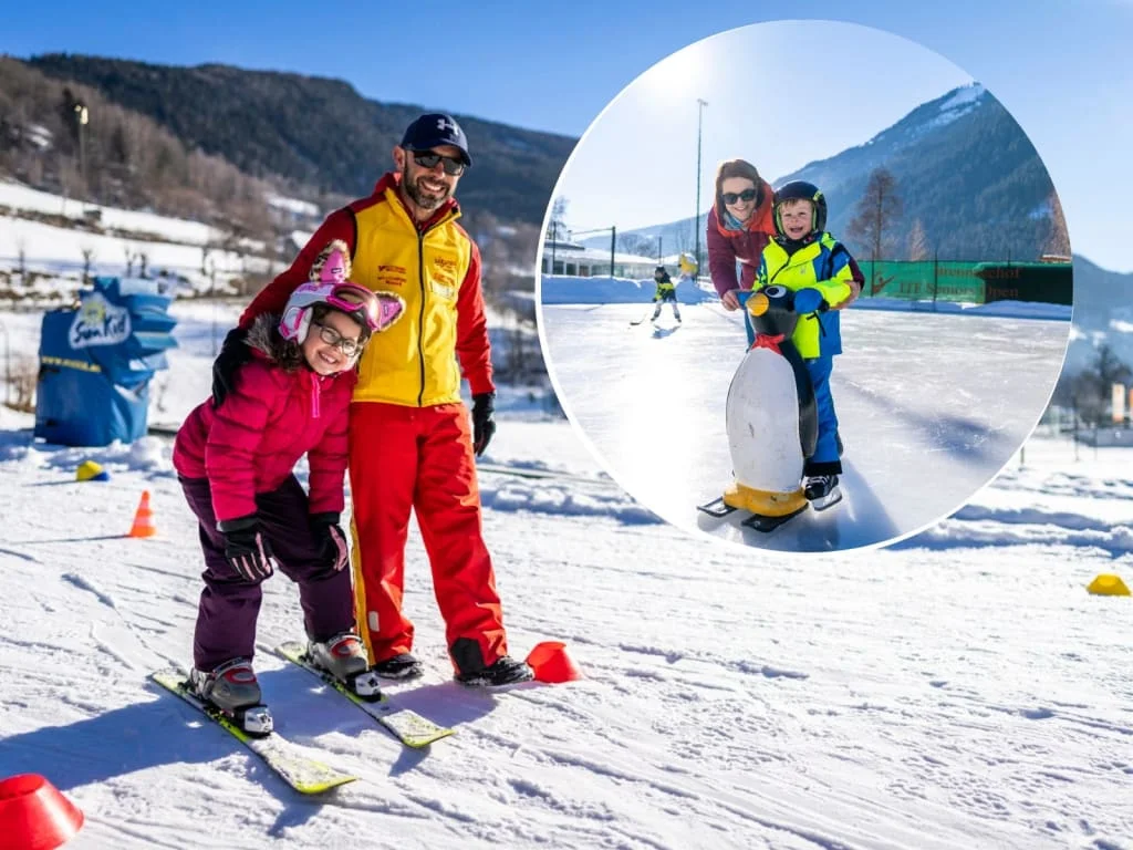 Ski instructor and children learning skiing and ice skating in sunny winter
