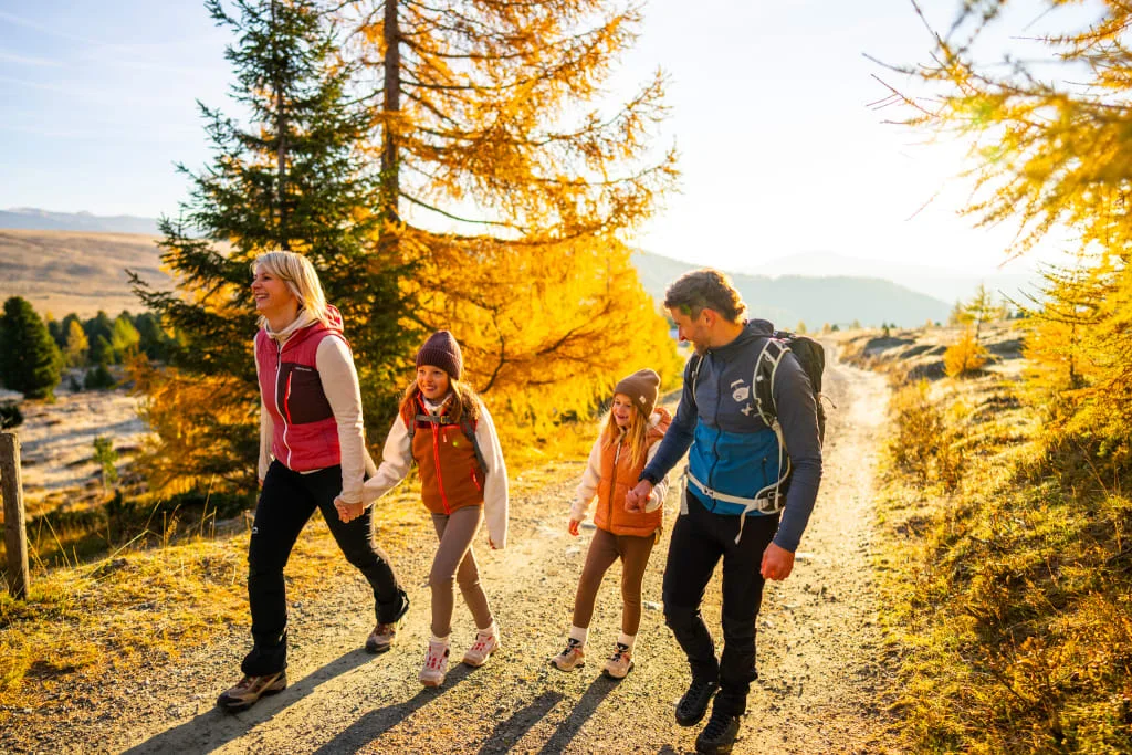 Family Autumn Special – Kids up to 12 years stay free Family hiking on a sunny forest trail in autumn