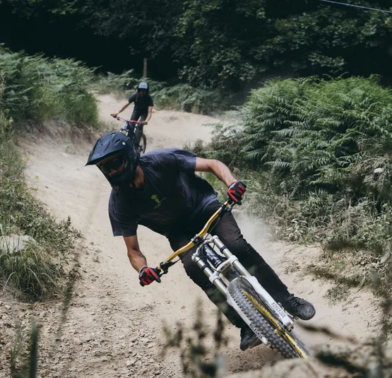Mountainbiker rijdt snel op stoffig bospad