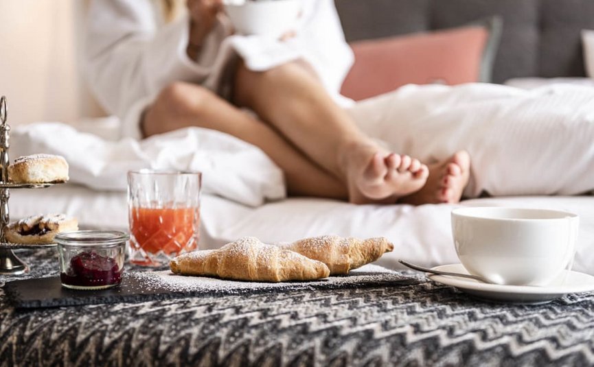 MIDWEEK SPECIAL Breakfast with croissants, juice, and coffee in bed with a relaxed person