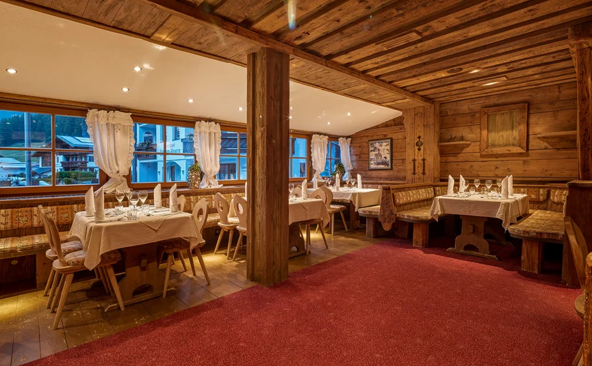 Cozy restaurant interior with wooden furniture and set tables