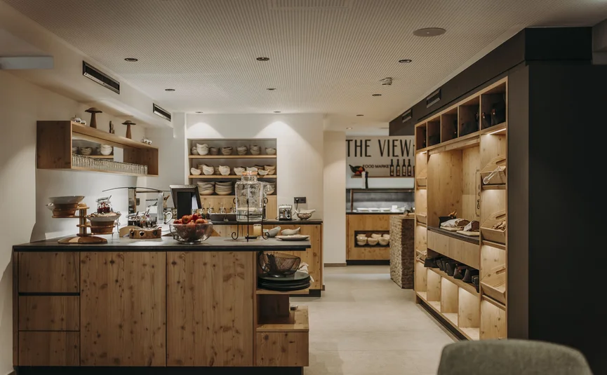 Modern breakfast area with wooden shelves and bowl of fruit