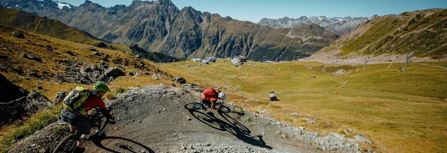 Ein perfektes Bike-Wochenende in Ischgl © Felix Saller Zwei Mountainbiker fahren eine steile Kurve auf einem Bergtrail