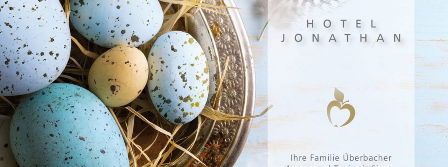 Colorful Easter eggs in a basket with text Happy Easter and Hotel Jonathan