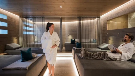 Relaxed man and woman in bathrobes in a modern wellness room
