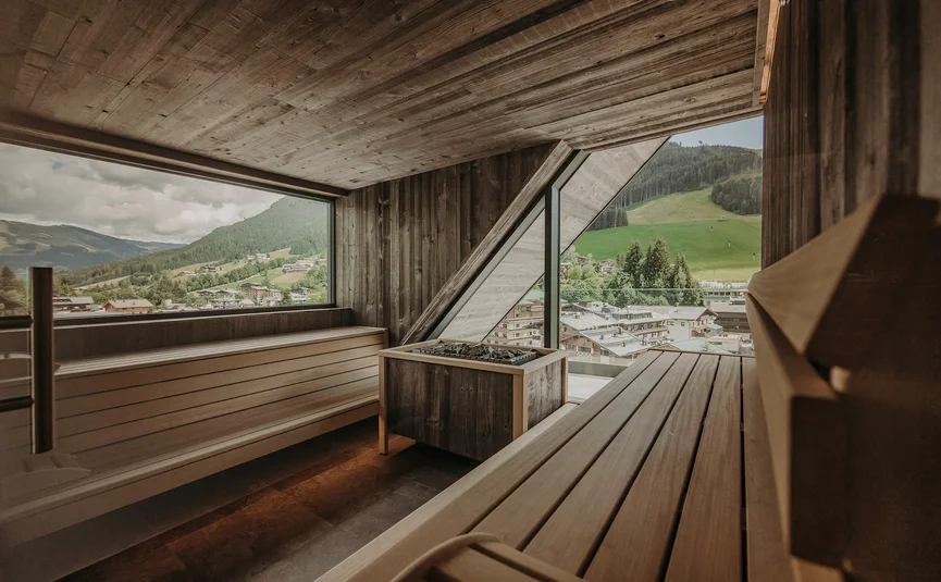 Sauna with wooden interior and panoramic mountain and village view