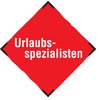 Rotes Schild mit weißer Aufschrift Urlaubsspezialisten