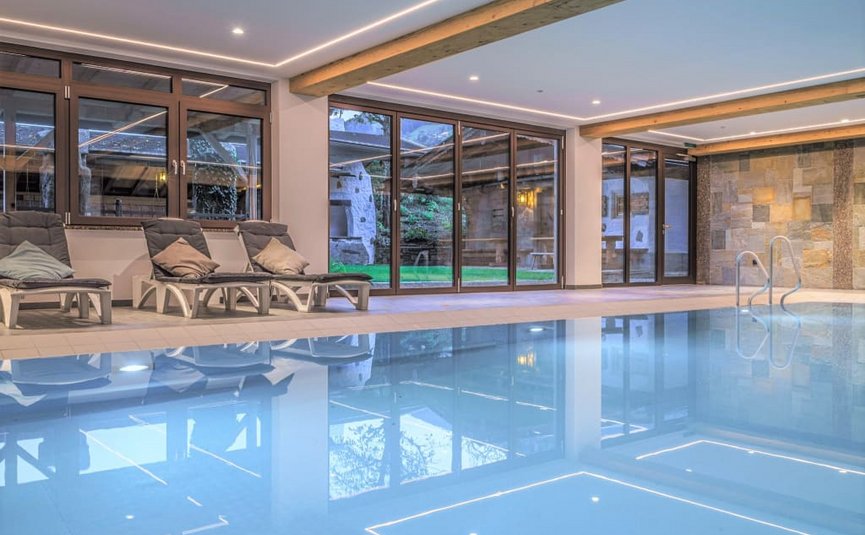 Activity holidays Indoor pool with lounge chairs and large windows overlooking a garden