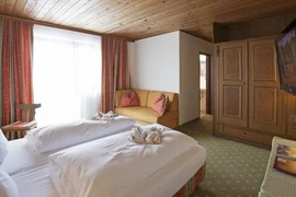 Cozy hotel room with wooden furniture and neatly folded bedding
