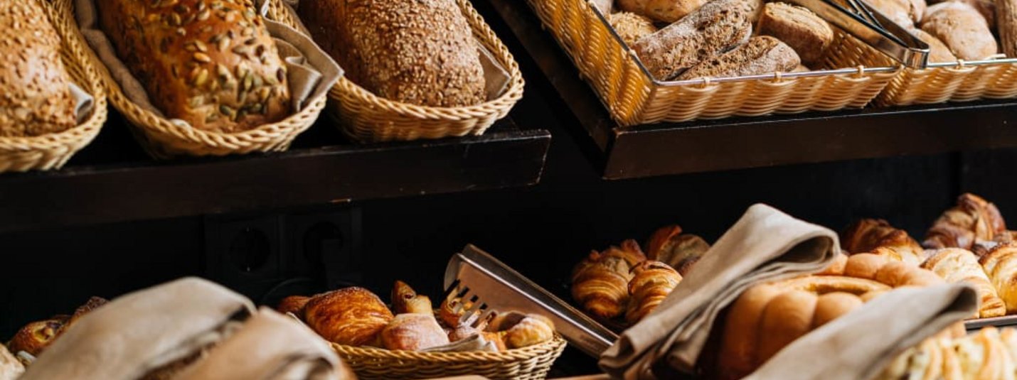 Various breads and pastries in baskets at a bakery